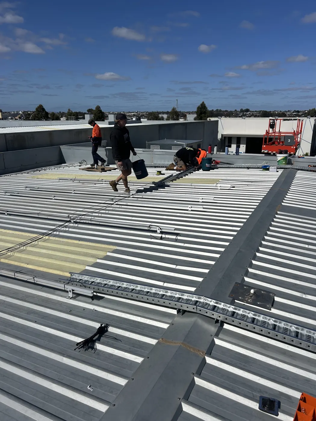 Infinity installers working on the factory roof in Wangara