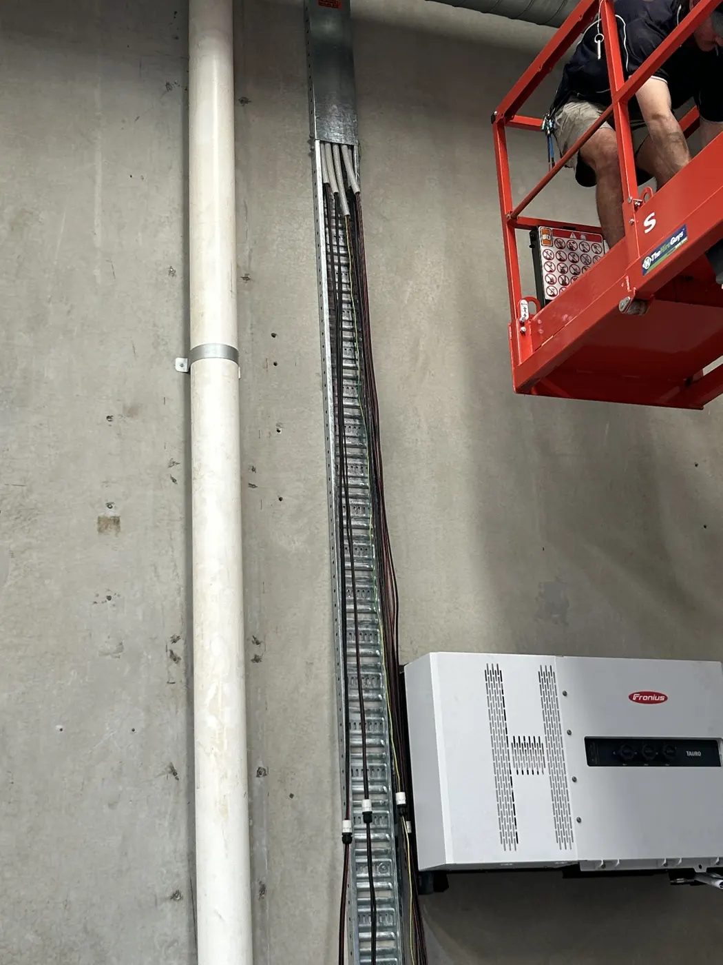 Inverter installed on the factory wall with an elevated work platform