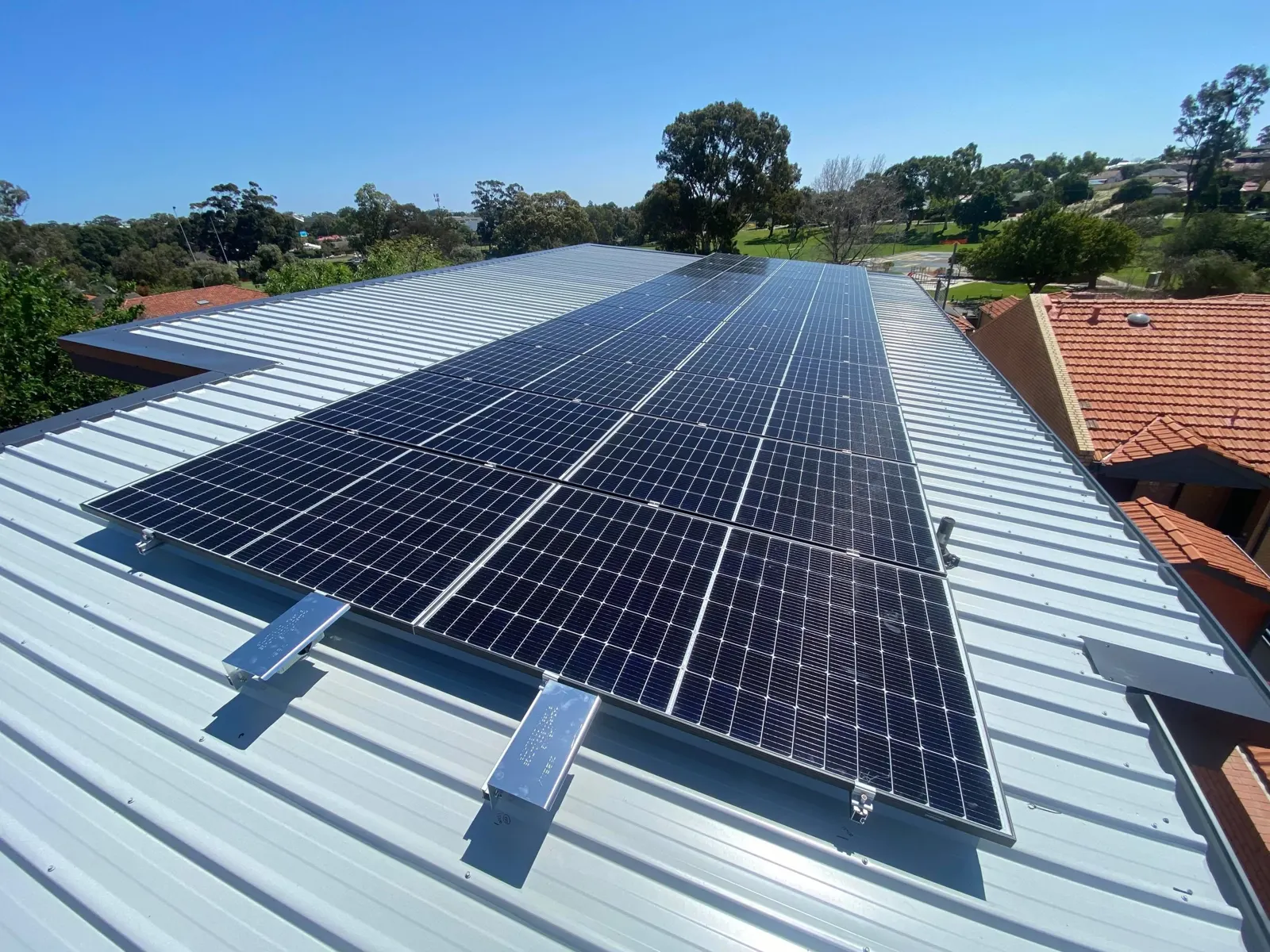 Black solar panels on a Perth home's metal roof