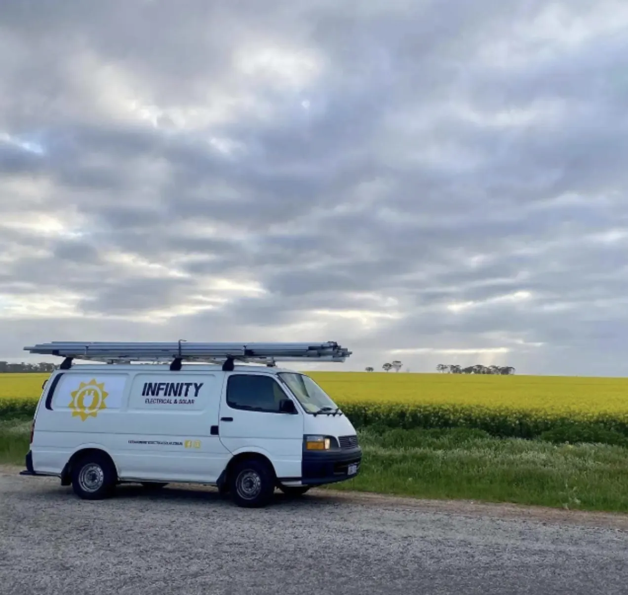 Infinity Electrical & Solar van beside a Wheatbelt canola field